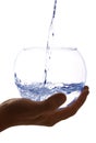 Water is poured into a large glass Royalty Free Stock Photo