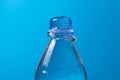 Water is poured out and a plastic bottle on a blue background. Royalty Free Stock Photo