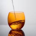 Water pouring into beautiful orange colour glass. Drink.