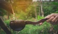 Water pouring in coconut shell and hand holding the water bowl Royalty Free Stock Photo