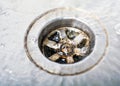 Some Water Pouring Down A Dirty Drain In A Kitchen Sink Royalty Free Stock Photo