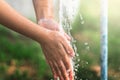 water pouring in faucet on hand child for cleaning Royalty Free Stock Photo