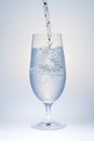 Water Pouring into Glass with Ice Royalty Free Stock Photo