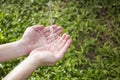 Water pouring in hands Royalty Free Stock Photo