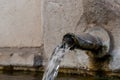 Water pouring out of an old iron spout