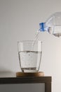 Water pouring from a plastic bottle in glass Royalty Free Stock Photo