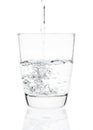 Water pouring into a tumbler glass isolated on white background. with clipping path Royalty Free Stock Photo