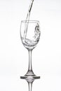 Water pouring into vine glass on white Royalty Free Stock Photo