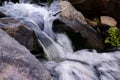 water pours over the earthstones. small stream. blue waters Royalty Free Stock Photo