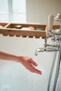 Water pours from the tap in the hands of the girl. the bathroom is bright. wedding concept