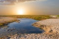 Water puddle in a prairie at the sunset Royalty Free Stock Photo