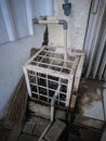 Water Pump in Cage for Protection, Water meters in a rusty metallic cage, rusty iron cage to cover the water pump Royalty Free Stock Photo