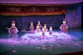 Water puppet show in Vietnam under purple lights Royalty Free Stock Photo