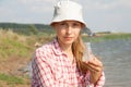 Water Purity Test. Woman holding chemical flask with water, lake or river in the background. Royalty Free Stock Photo