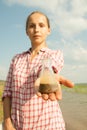 Water Purity Test. Woman holding chemical flask with water, lake or river in the background. Royalty Free Stock Photo