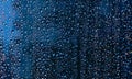 Water and rain drops on the glass, abstract view, Drops of rain on blue glass background / drops on glass after rain Royalty Free Stock Photo