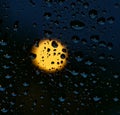 Water and rain drops on the glass and full moon in the background, abstract view, Drops of rain on blue glass background / drops o Royalty Free Stock Photo