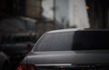 Water rain drops on rear wind shield mirror of car on traffic road background in winter raining moment