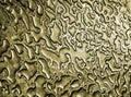 Water after rain on a gold metallic steel surface Royalty Free Stock Photo