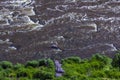 Water Rapids on a mountain river top view. Granite boulders with river