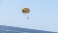 Water recreation. Launch a skydiver on a yellow parachute with a painted smile