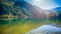 The water reflection of Arrow Bamboo Lake during noon with green yellow autumn trees , Jiuzhaigou, Sichuan, China Royalty Free Stock Photo