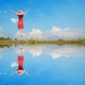 Water Reflection Happy Woman Jumping with blue sky Royalty Free Stock Photo