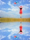 Water Reflection Happy Woman Jumping with blue sky Royalty Free Stock Photo