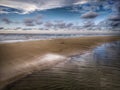 Water reflection on the sea shore landscape on the sea shore with blue sky above. Royalty Free Stock Photo