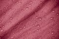 Water-repellent fabric in large raindrops. Burgundy rip-stop fabric. Tent textiles.
