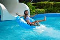 The water rides in the tropics. Girl swims in the water Park.