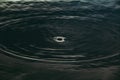 Water ripple hole in dark or black tone.