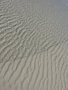 Water ripples over beach sand patterns Royalty Free Stock Photo