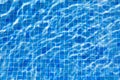 Water ripples in swimming pool, blue background Royalty Free Stock Photo