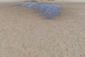 Water rivulets making their way across a sandy beach reflecting blue sky, creative copy space Royalty Free Stock Photo