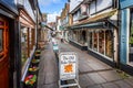 Water running down a culvert in Medieval Cheap Street in Frome, Somerset, UK