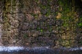 Water running down a stone wall as a part of a fountain Royalty Free Stock Photo