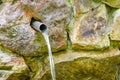 Water running from outdoor wall faucet Royalty Free Stock Photo