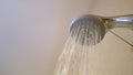 Water running from shower head and faucet in modern bathroom. Fresh shower behind wet glass window with water drops Royalty Free Stock Photo