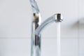 Water running from a tap into a bathroom sink Royalty Free Stock Photo