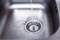 Water running from the tap to kitchen sink. Fresh water saving concept Royalty Free Stock Photo