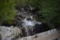 Water running under a small wooden foot bridge