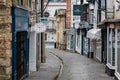 Water runs down a culvert in deserted Cheap Street, in Frome, Somerset, England