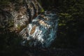 water rushes down a cascading waterfall deep within the forrest.