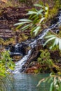 Water rushing over natural steps of sediment rock at Fortescue Falls at the bottom of Dales Gorge Karijini National Park Royalty Free Stock Photo