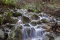 Water rushing over rocks in a stream Royalty Free Stock Photo