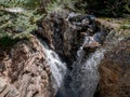 Water rushing over the edge of a mountian stream Royalty Free Stock Photo