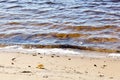 Water\'s edge on the shore. Wave of blue sea on sandy beach