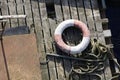 Water safety buoy red white ring aerial view from above on wooden raft Royalty Free Stock Photo