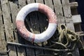 Water safety buoy red white ring aerial view from above on wooden raft Royalty Free Stock Photo